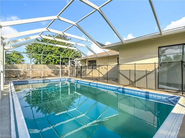 View of pool featuring a lanai, a sunroom, and a patio