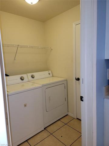 Laundry room with closet