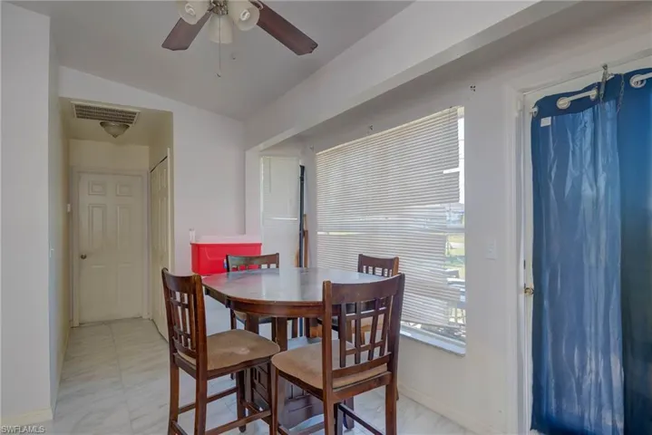 Dining area with visible vents, baseboards, and a ceiling fan