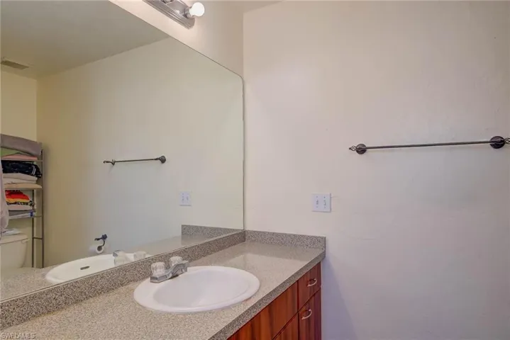 Bathroom with visible vents, toilet, and vanity