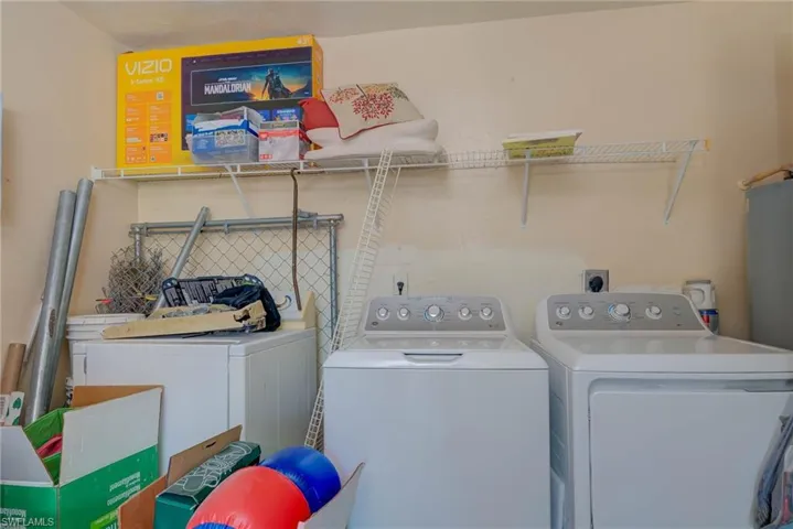 Laundry room featuring independent washer and dryer and laundry area