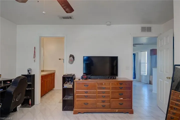 Bedroom featuring visible vents and a ceiling fan