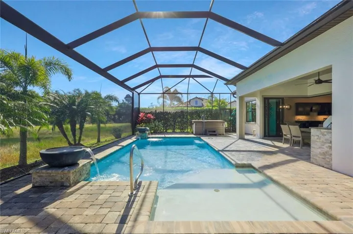Pool with a patio, a lanai, a ceiling fan, and a hot tub