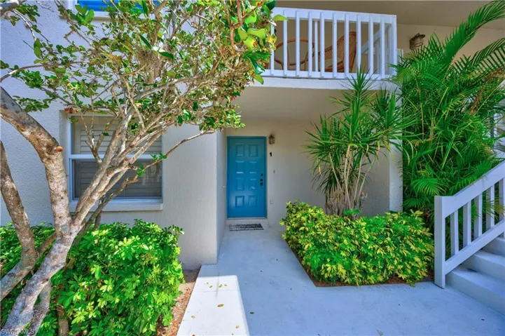 Doorway to property featuring stucco siding