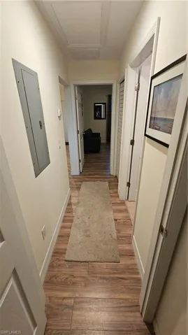 Wood-finish flooring throughout, white wall trim, and light-toned walls