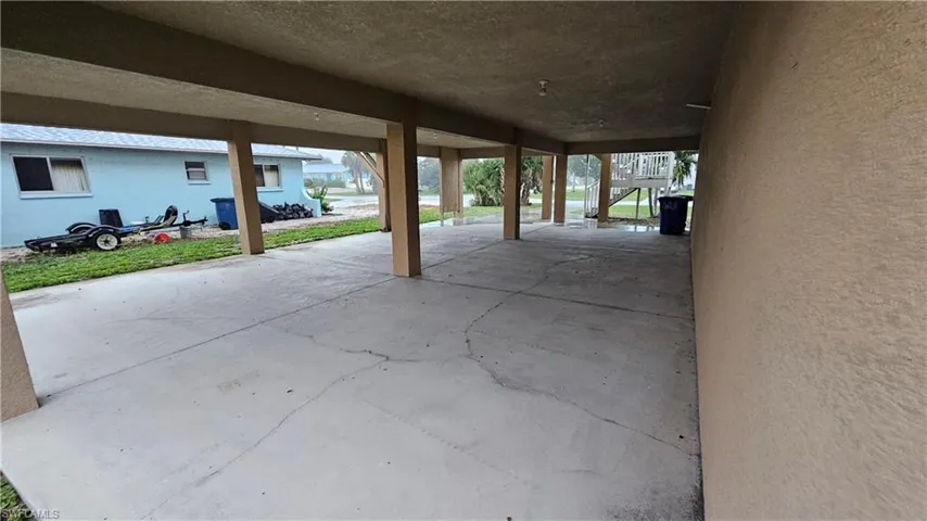 Covered open-air concrete ground level with structural columns