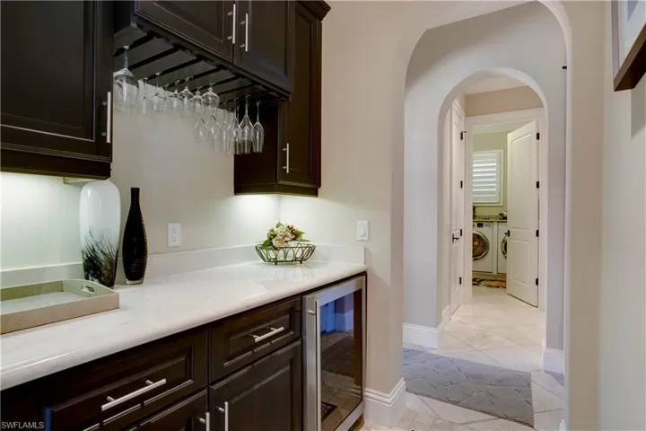 Butlers Pantry and Wine Bar with beverage cooler and arched walkways