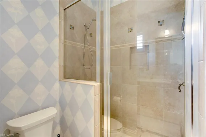 Full bathroom featuring a shower stall