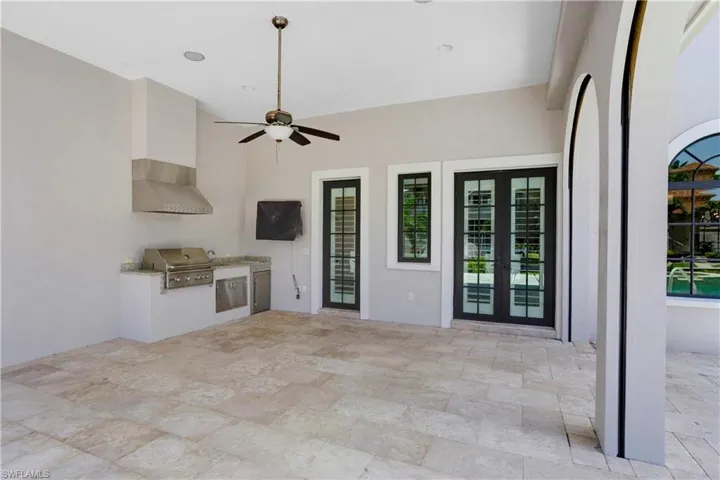 View of patio featuring exterior kitchen, ceiling fan, and french doors