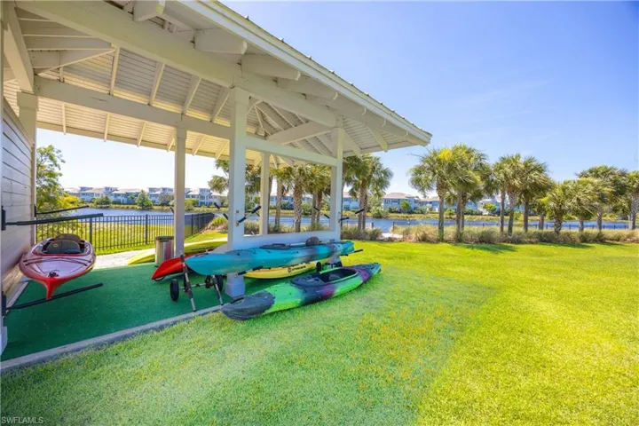 View of property's community with a water view and a patio