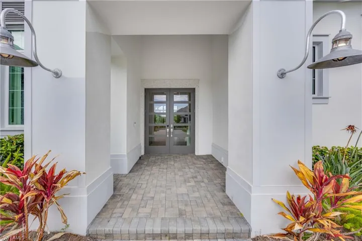 Property entrance with stucco siding and french doors