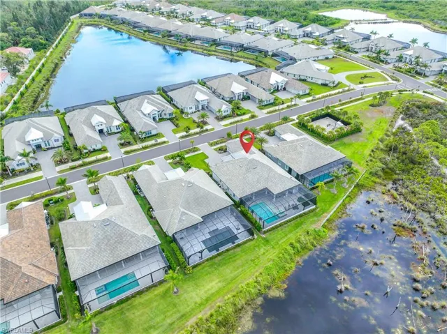 Aerial view of residential area featuring a nearby body of water