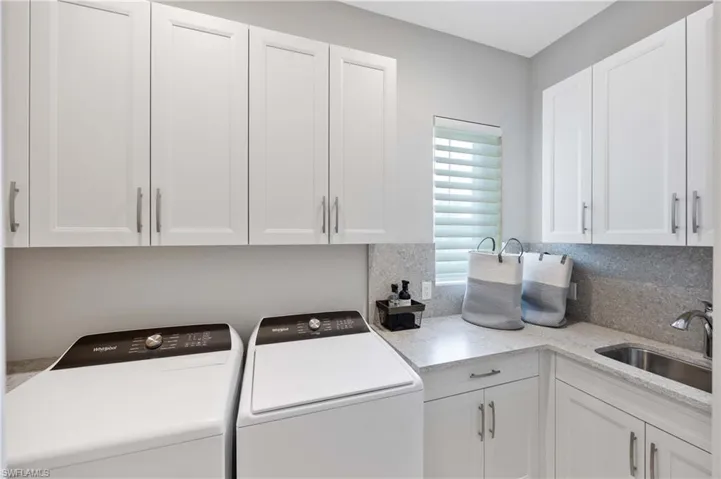 Washroom with cabinet space and washer and dryer
