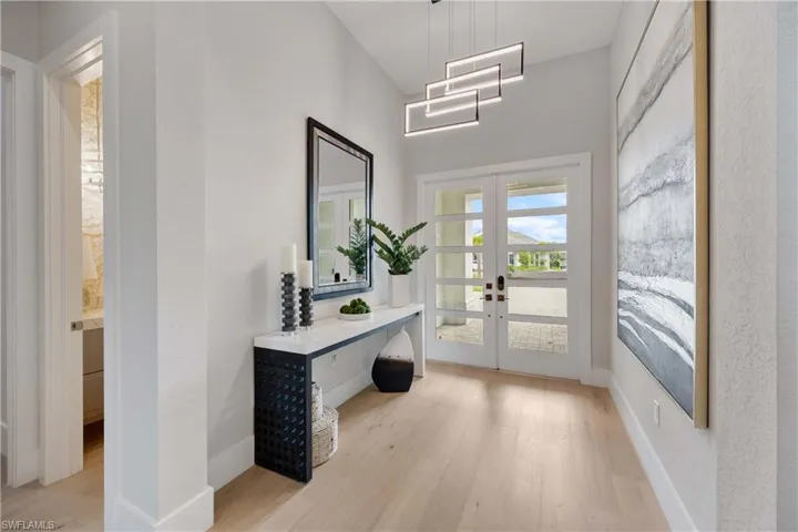 Entryway with wood finished floors and french doors