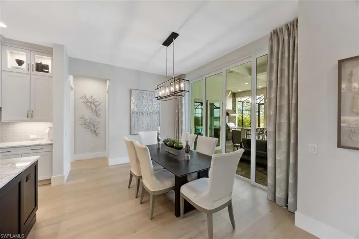 Dining space with light wood-style flooring and a chandelier