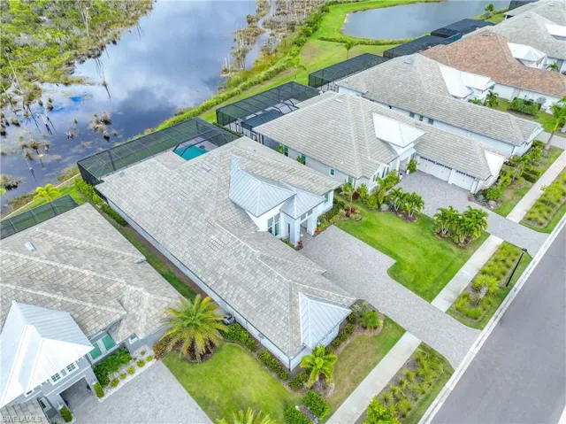 Aerial perspective of suburban area featuring a large body of water