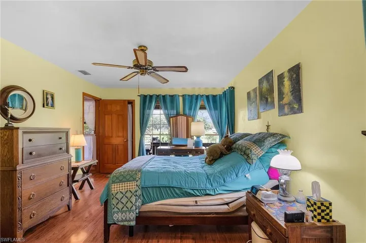 Bedroom featuring wood finished floors and ceiling fan