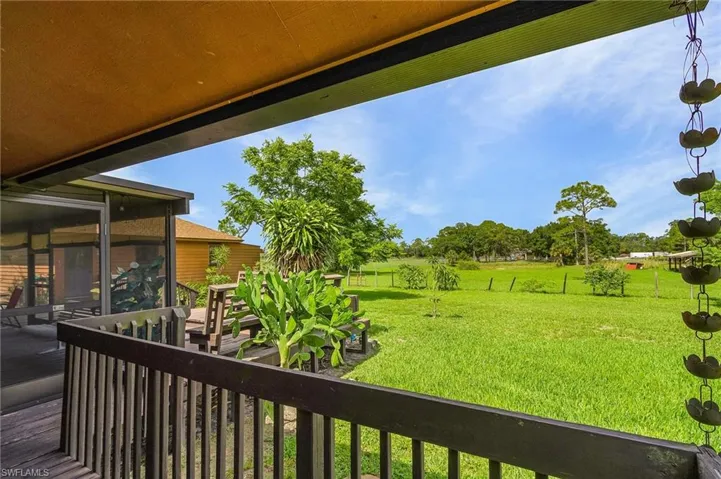 View of green lawn featuring a sunroom