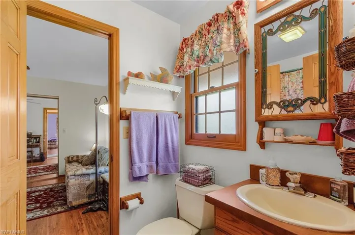 Full bath featuring vanity and wood finished floors