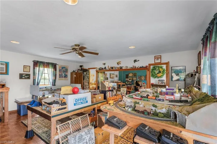 Living area with a ceiling fan and recessed lighting