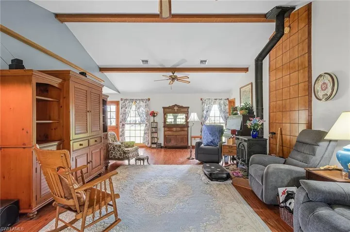 Living room with wood finished floors and a ceiling fan