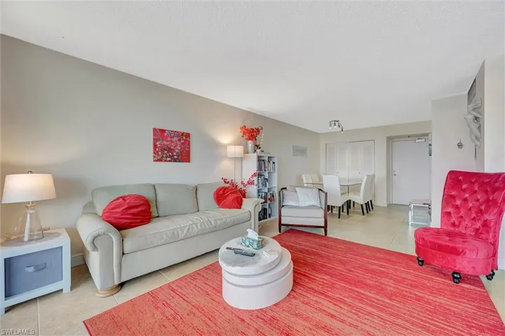 Living room with light tile patterned floors and a textured ceiling