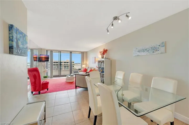 Dining room with expansive windows and light tile patterned floors