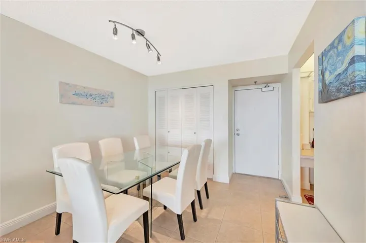 Dining area with light tile patterned flooring and baseboards