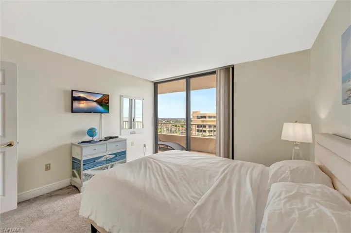 Carpeted bedroom featuring access to outside and floor to ceiling windows