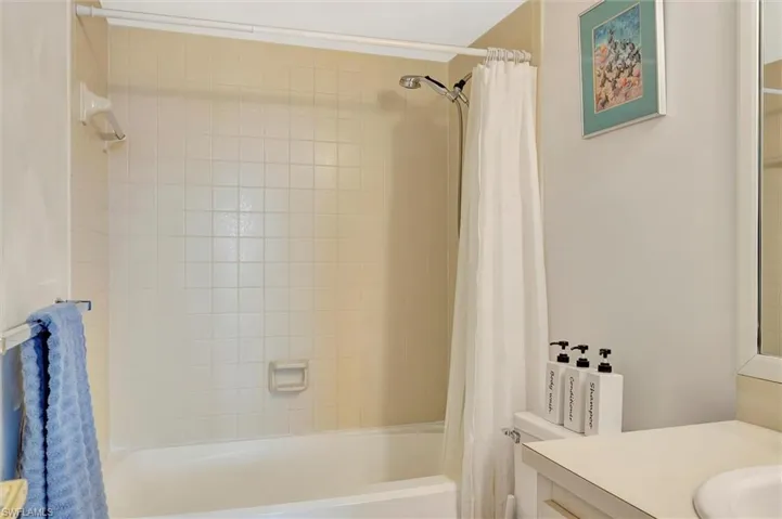 Full bathroom with vanity and shower / bathtub combination with curtain