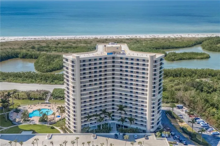 Drone / aerial view of a large body of water and a pool