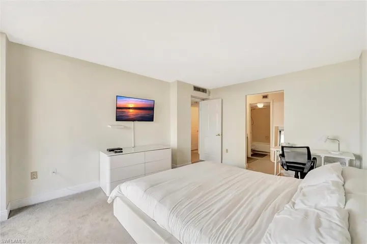 Bedroom with light carpet and baseboards
