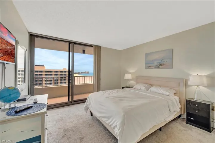 Bedroom featuring carpet floors, access to outside, and floor to ceiling windows