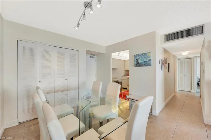 Dining room with light tile patterned floors and baseboards