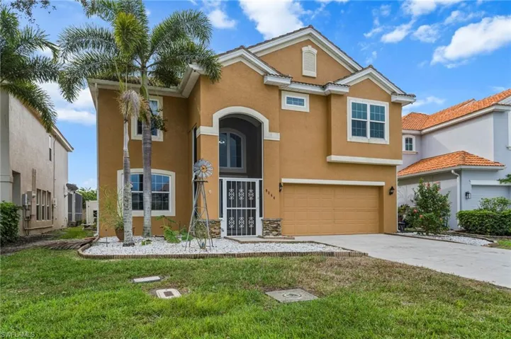 View of front of home featuring stucco siding, concrete driveway, a garage, and a front yard