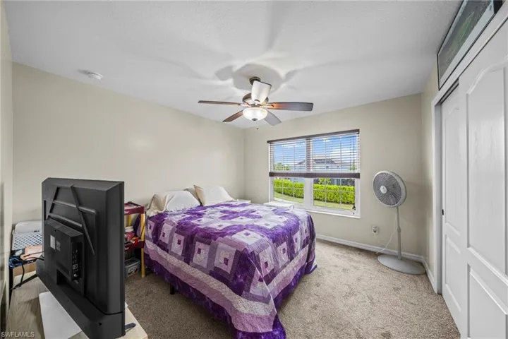 Bedroom featuring a closet, carpet floors, and ceiling fan