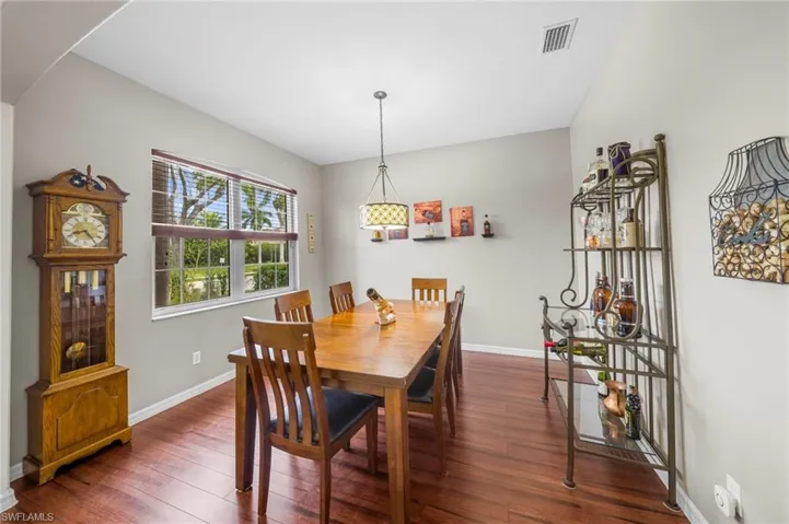 Dining area with baseboards and dark wood-style flooring