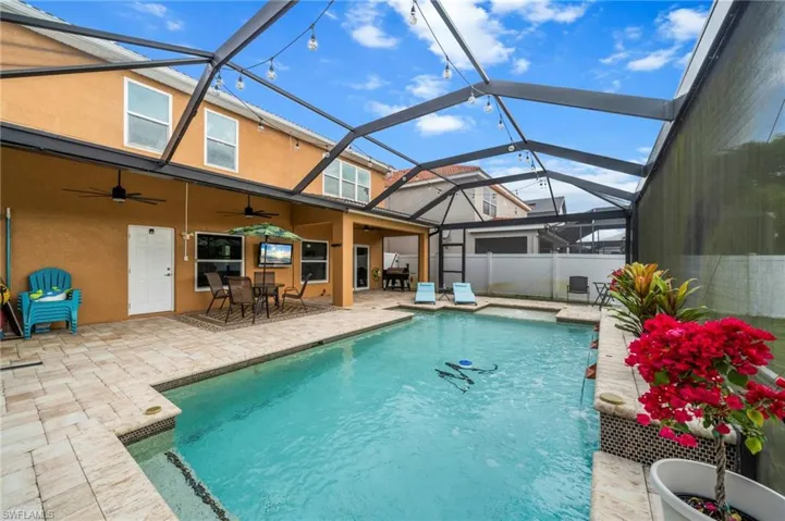View of pool featuring a lanai, a patio, a sunroom, and outdoor dining space