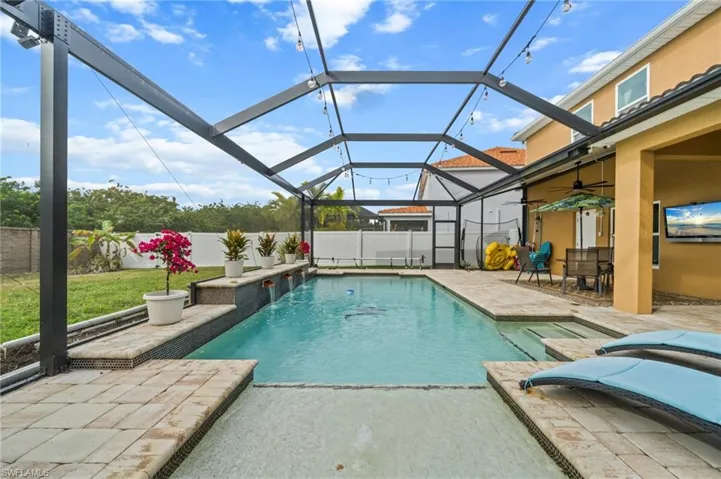 View of pool featuring a patio area, a lanai, a sunroom, and a fenced backyard