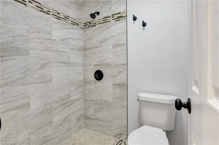 Bathroom with tiled shower and toilet