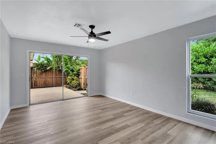 Primary bedroom featuring LVT flooring and ceiling fan
