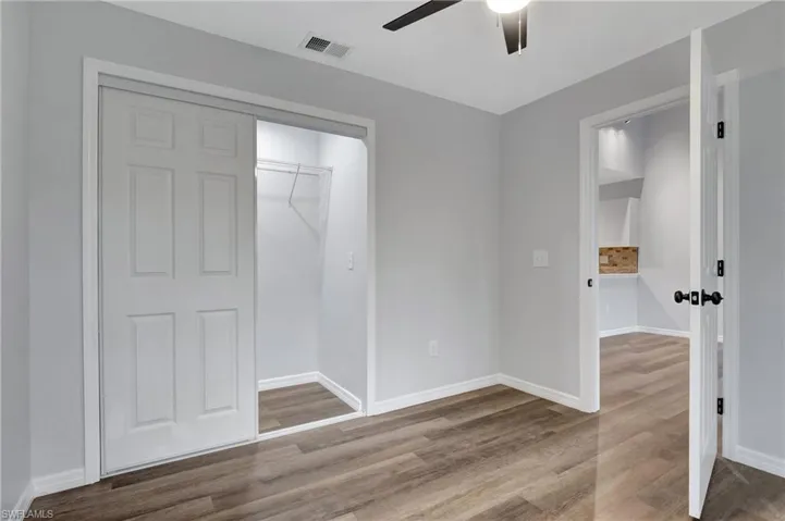 Bedroom featuring a closet, ceiling fan, and LVT flooring
