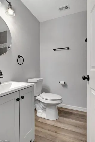 Bathroom with vanity, toilet, and LVT floor
