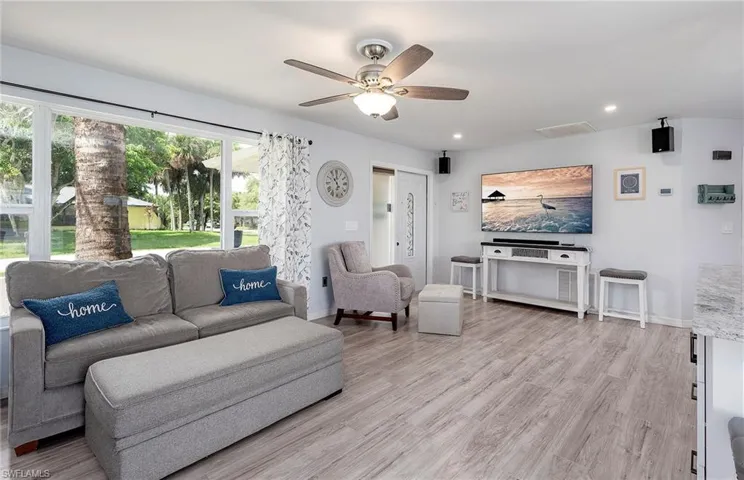 Living room featuring light hardwood / wood-style floors and ceiling fan