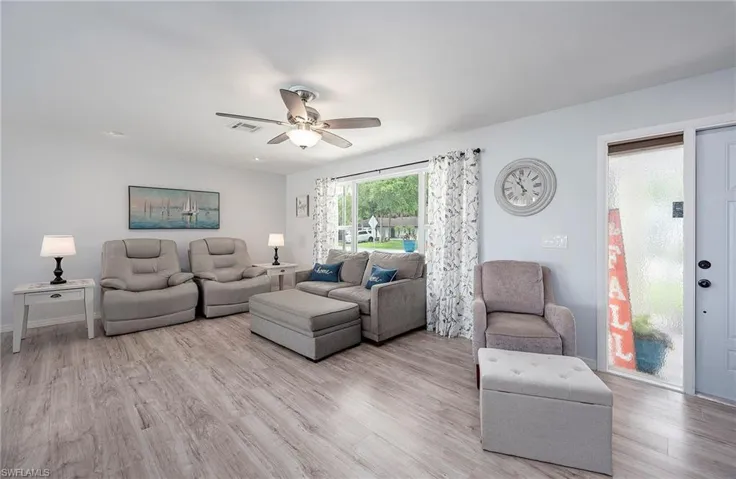 Living room featuring light wood-type flooring and ceiling fan
