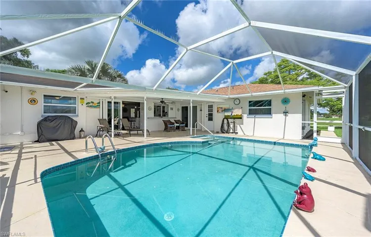 View of swimming pool featuring a lanai, a patio area, and ceiling fan