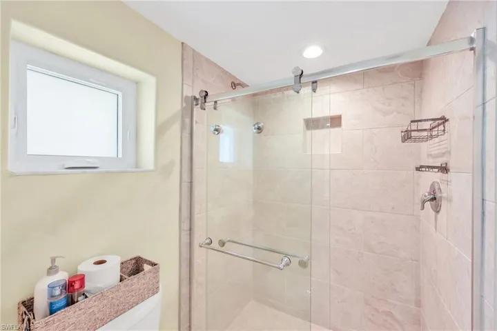 Bathroom featuring a stall shower and toilet