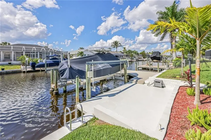 Dock area with a water view and boat lift
