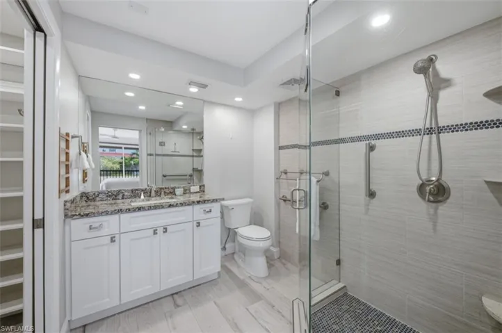 Master bathroom with glass shower and walk in closet
