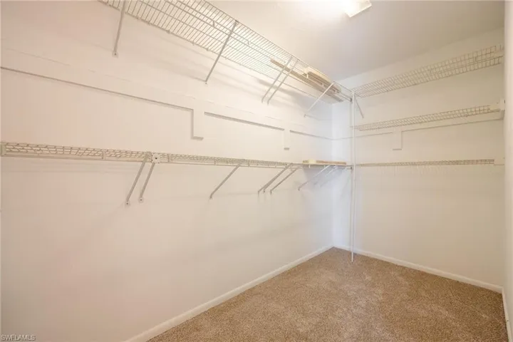 Walk in closet featuring carpet flooring